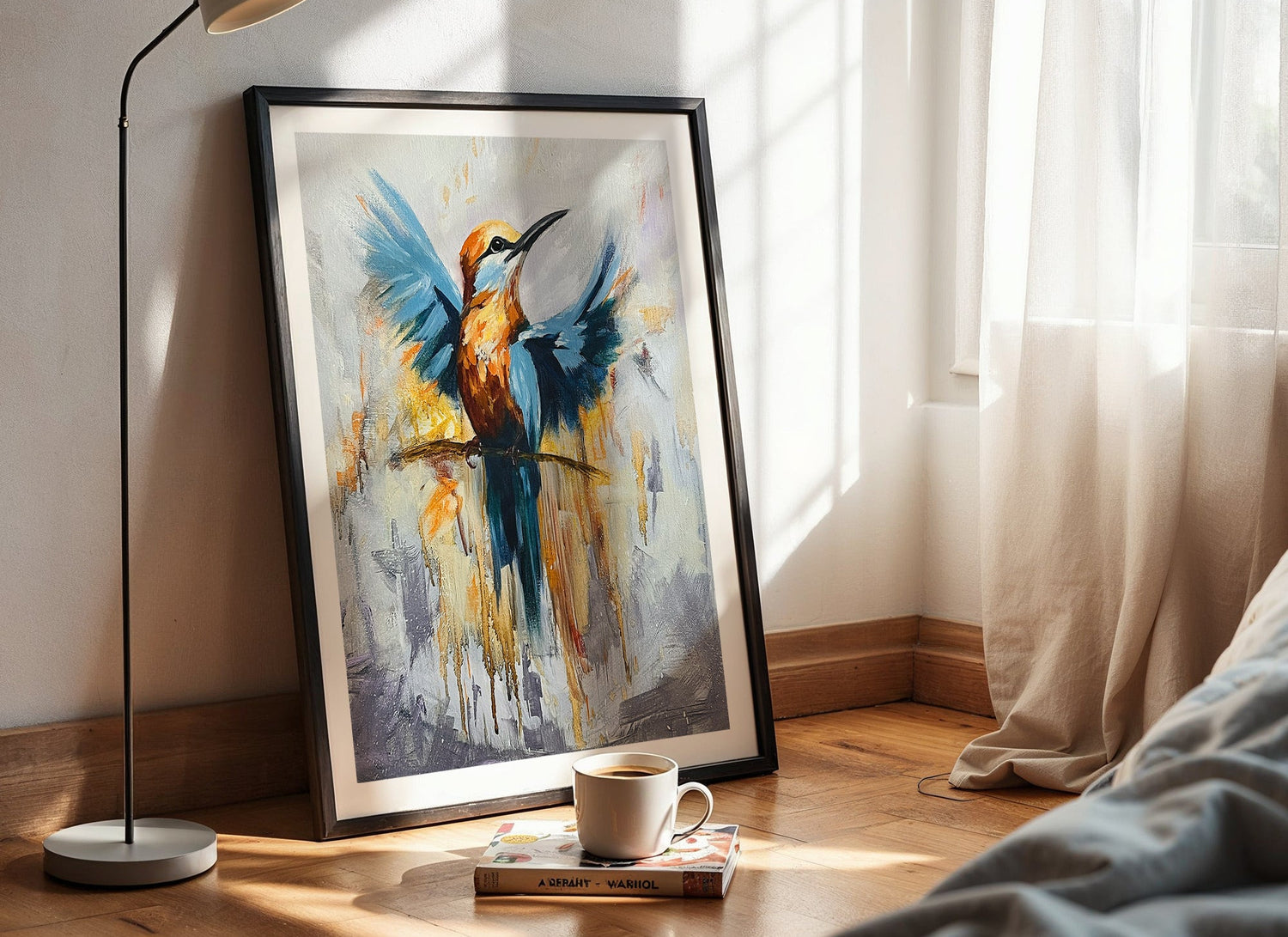 Framed abstract painting of a bird on a wall next to a bed with a lamp and cup.