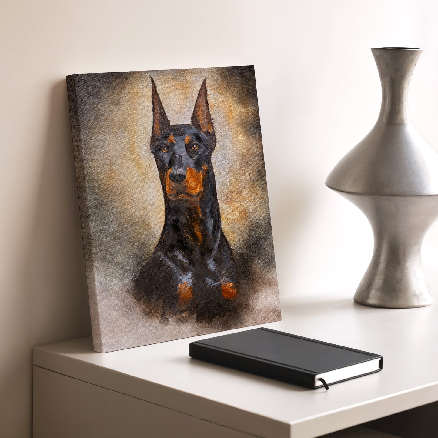 Canvas print of a dog on a table next to a notebook and decorative vase.