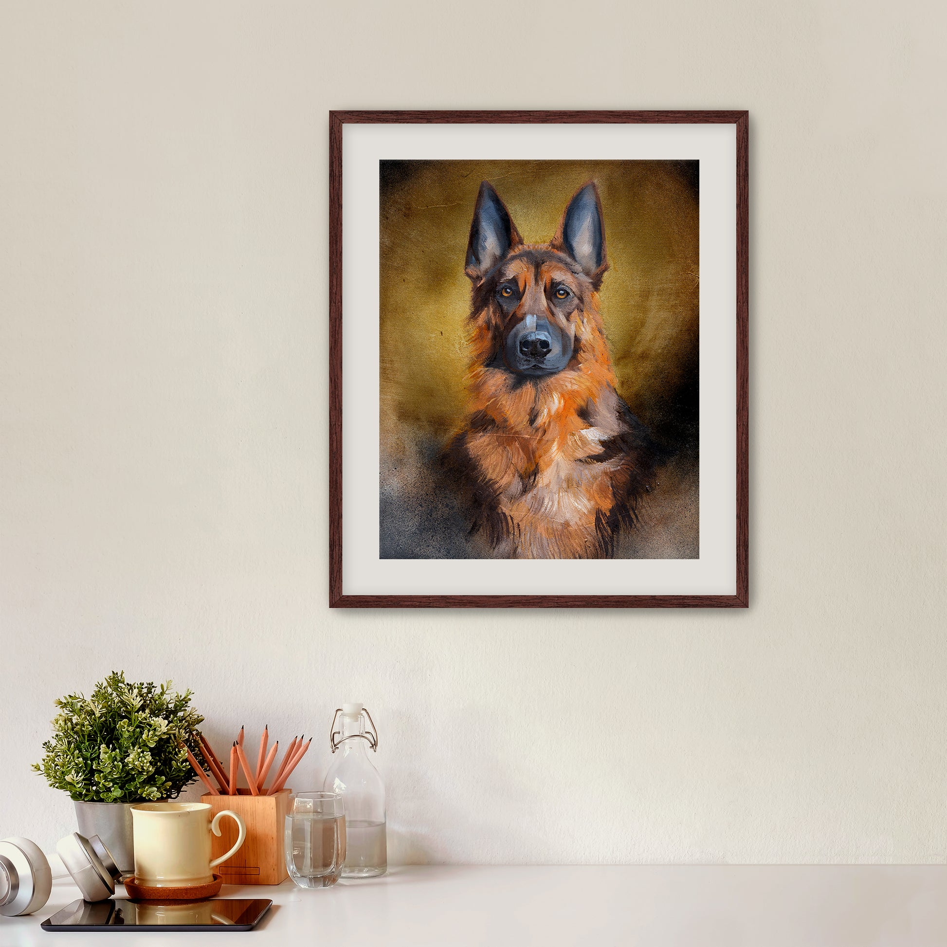 Framed portrait of a German Shepherd on a wall above a desk with office supplies.
