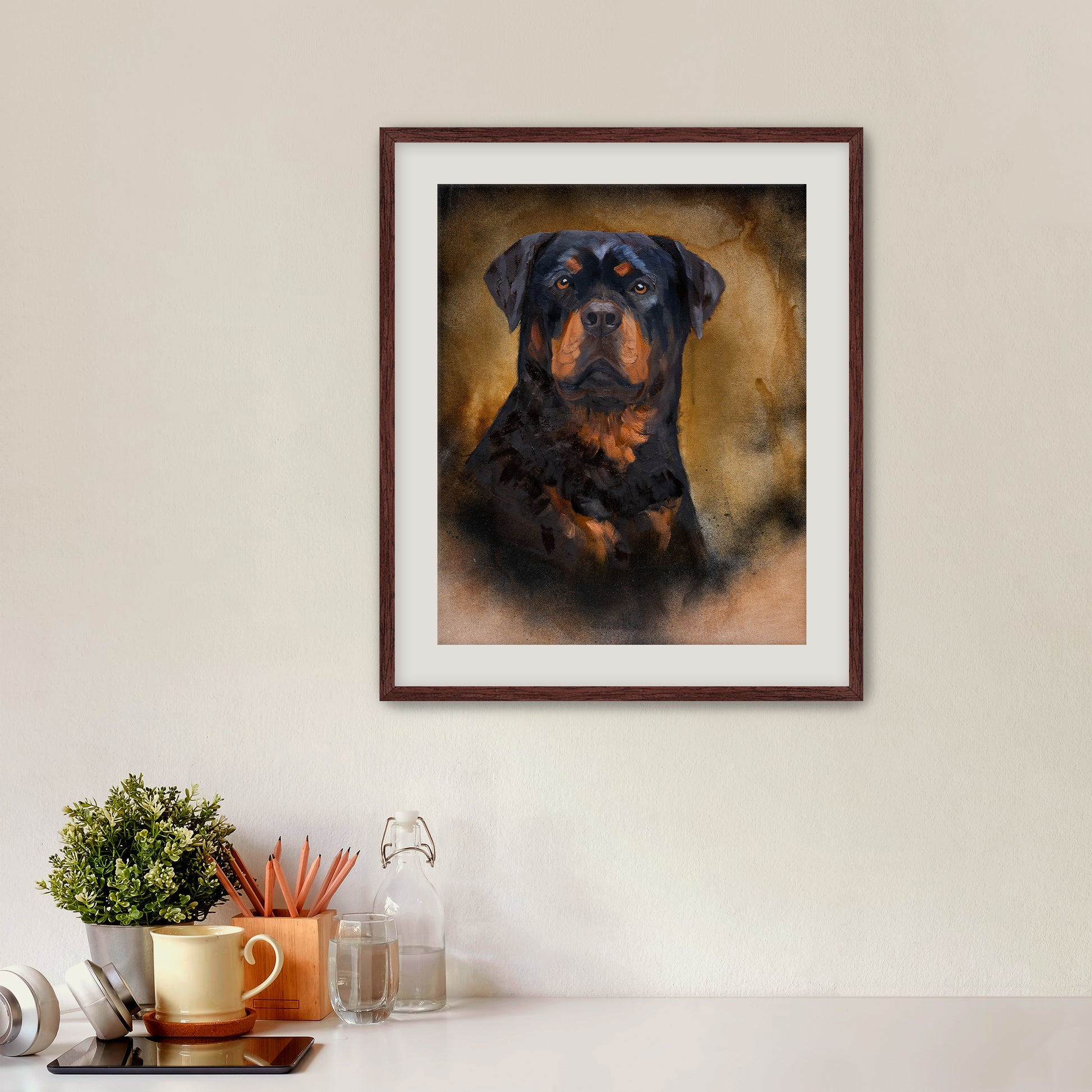Framed portrait of a Rottweiler on a wall above a desk with office supplies.